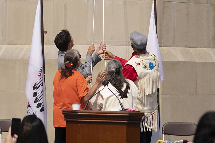 Prime Minister Trudeau joins in the official raising of the Survivors' flag with Residential School survivor and Kitigan Zibi Elder Florence Cote.