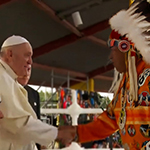 Beside the former Chief of Ermineskin Cree Nation, Pope Francis shakes hands with former Chief of Samson Cree Nation.