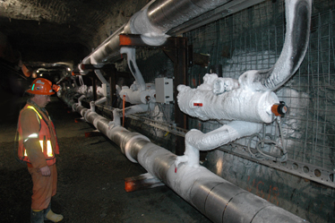 A mine worker inspects the underground pipes used for the frozen block method, which have started to get covered in ice.